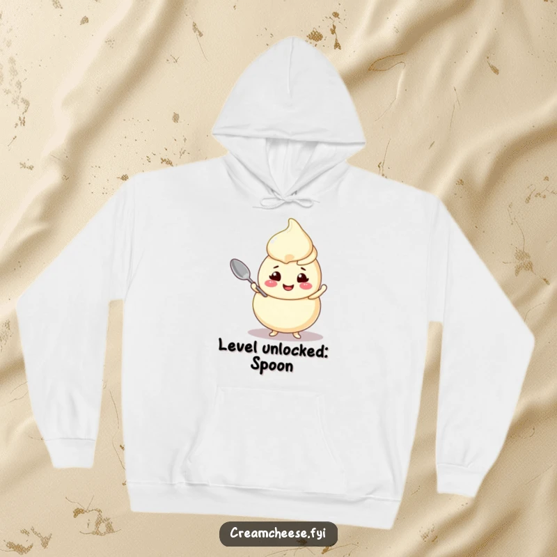 Funny cream cheese swirl hoodie, a cheerful character expertly balancing a tiny spoon, embodying playful balance.
