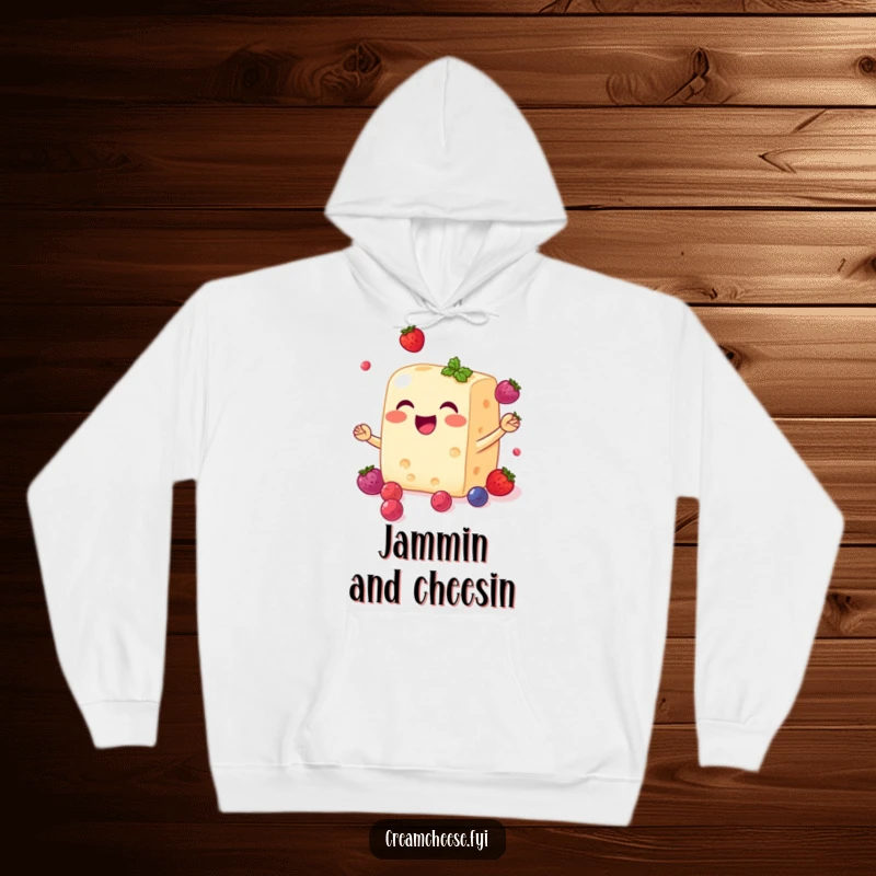 Funny cream cheese block hoodie with a smiling face, joyfully juggling small, sweet berries, warm and delightful.