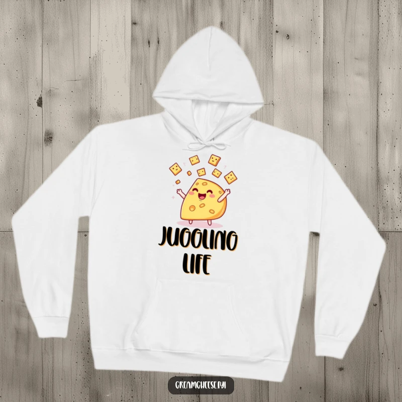 Funny cheese wedge hoodie, showing a happy wedge character skillfully juggling tiny crackers with a cheerful demeanor.